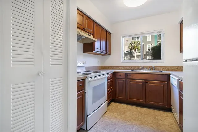 a kitchen with stainless steel appliances granite countertop a stove and a sink