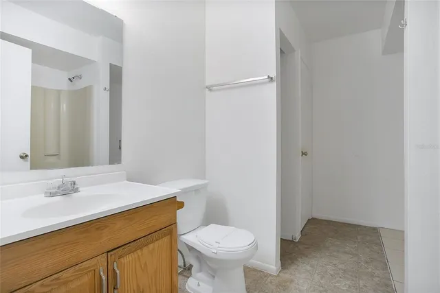 a bathroom with a sink toilet and a mirror