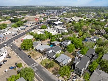 an aerial view of residential houses with outdoor space