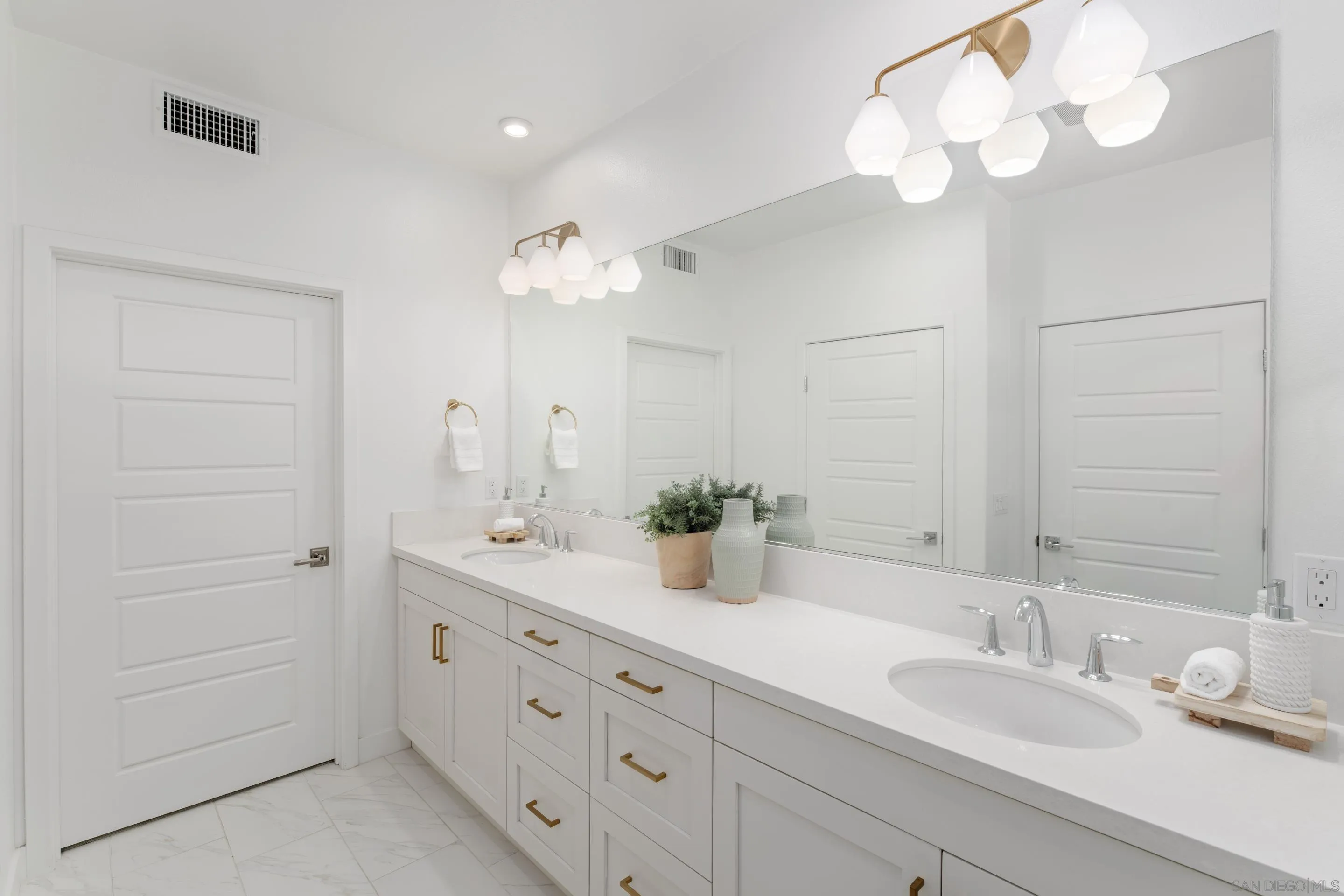 2731 Via Avella San Diego, CA 92108 - Photo 11 of 39 a bathroom with a double vanity sink and a mirror