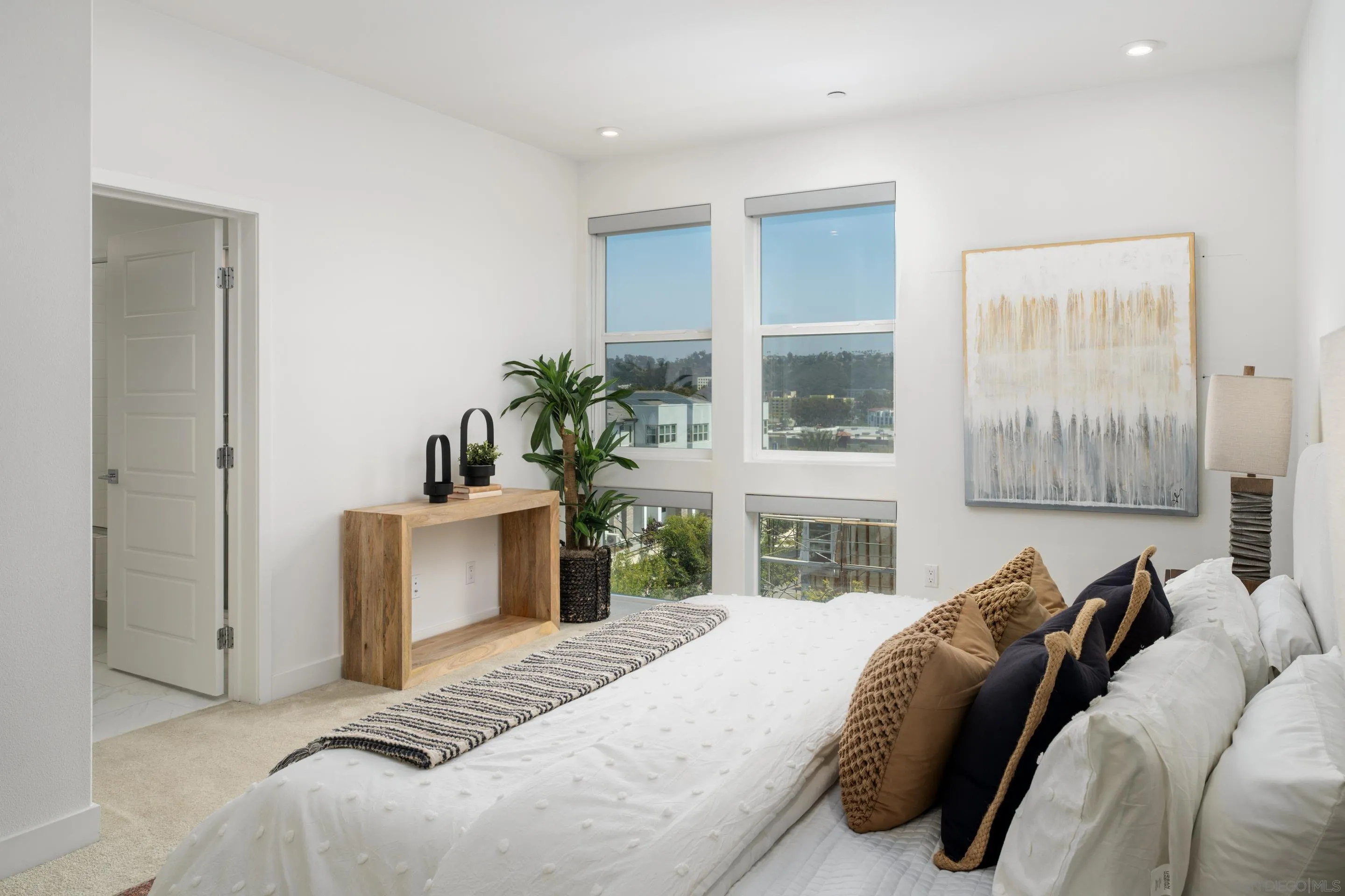 2731 Via Avella San Diego, CA 92108 - Photo 13 of 39 a bedroom with a bed and a potted plant