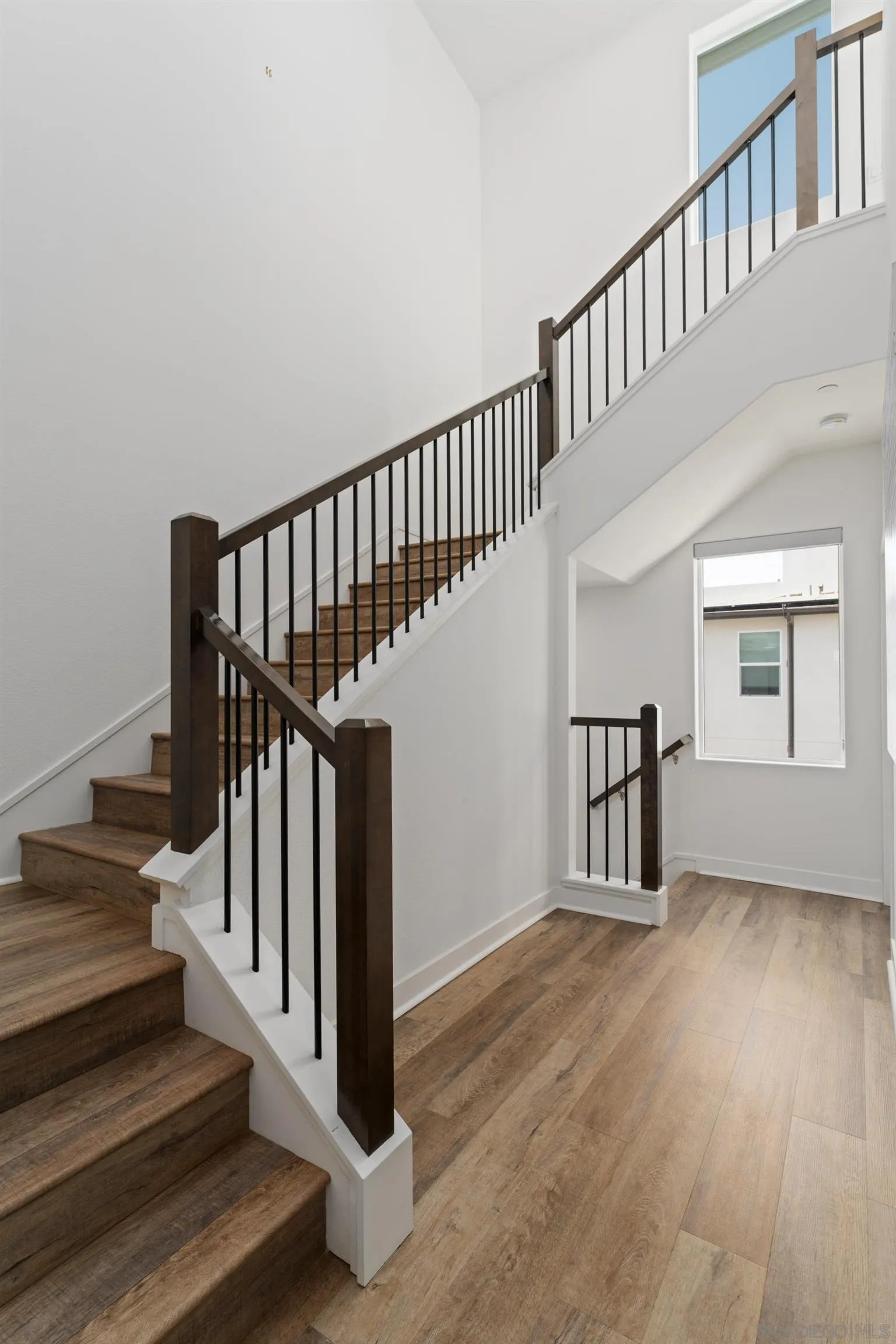 2731 Via Avella San Diego, CA 92108 - Photo 14 of 39 a view of entryway and hall with wooden floor