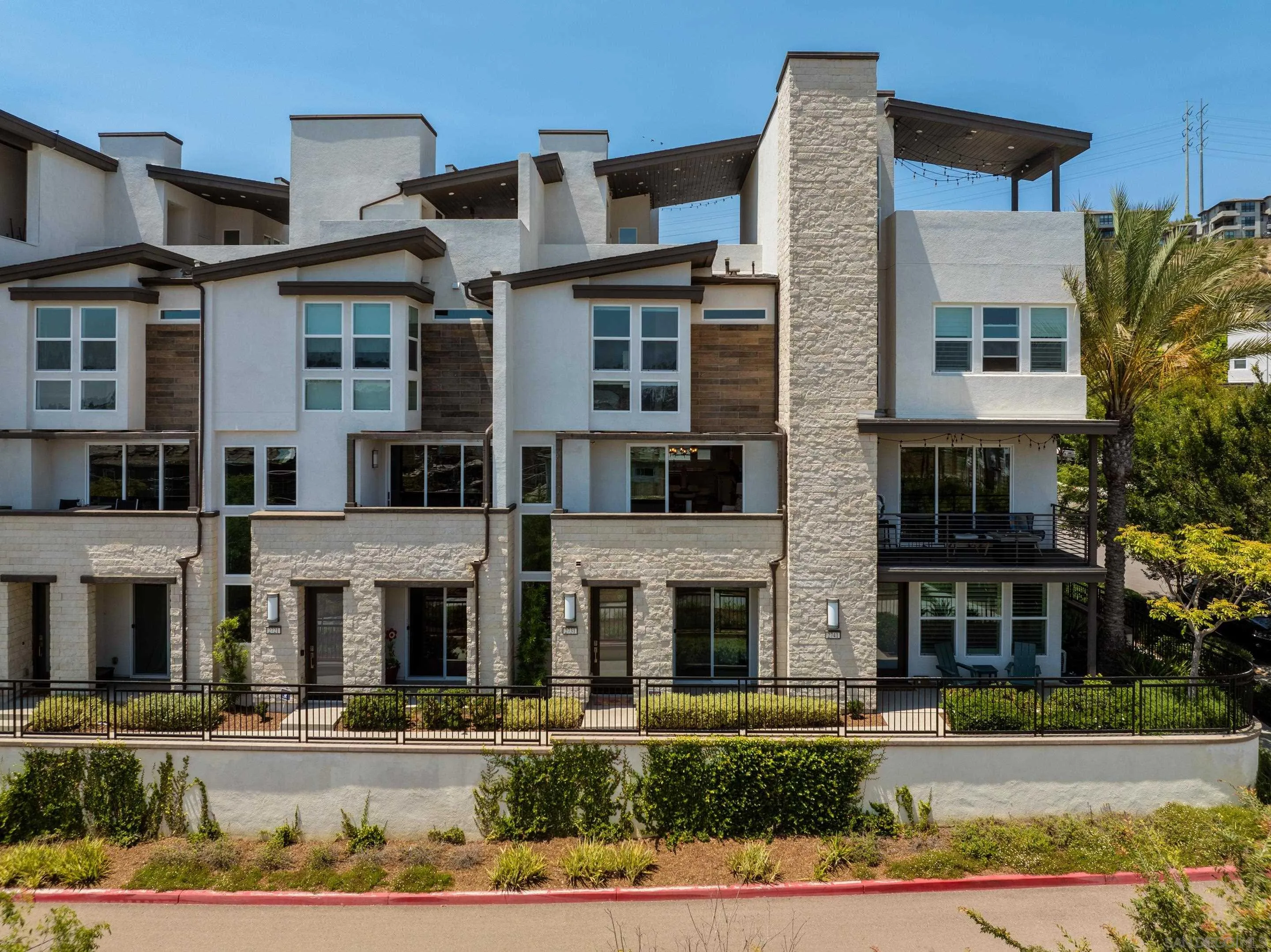 2731 Via Avella San Diego, CA 92108 - Photo 38 of 39 a front view of a residential apartment building with a yard and entryway