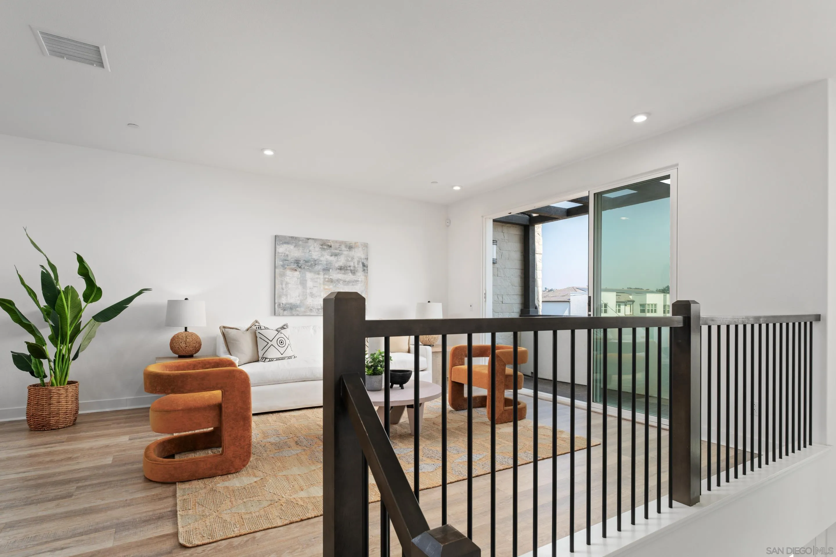 2731 Via Avella San Diego, CA 92108 - Photo 4 of 39 a hallway with a dining table and chairs