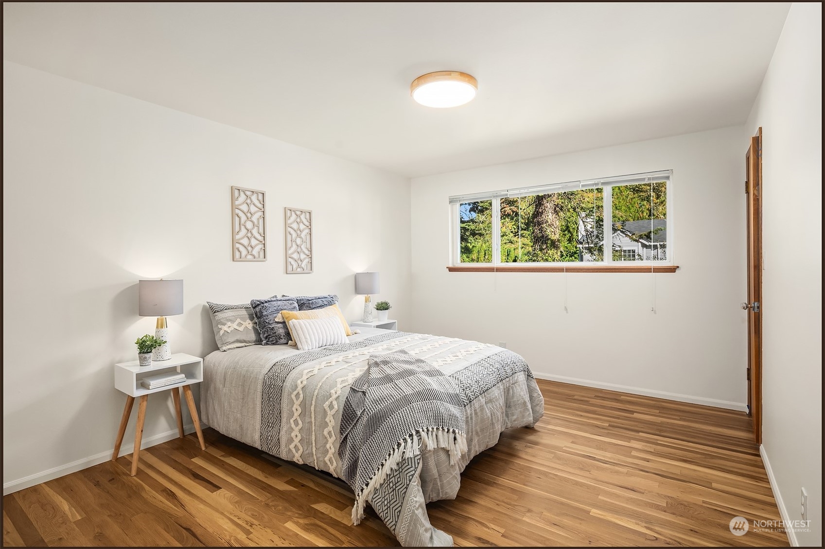 1834 North 183rd Street Shoreline, WA 98133 - Photo 18 of 40 a bed room with a bed and a painting on the wall