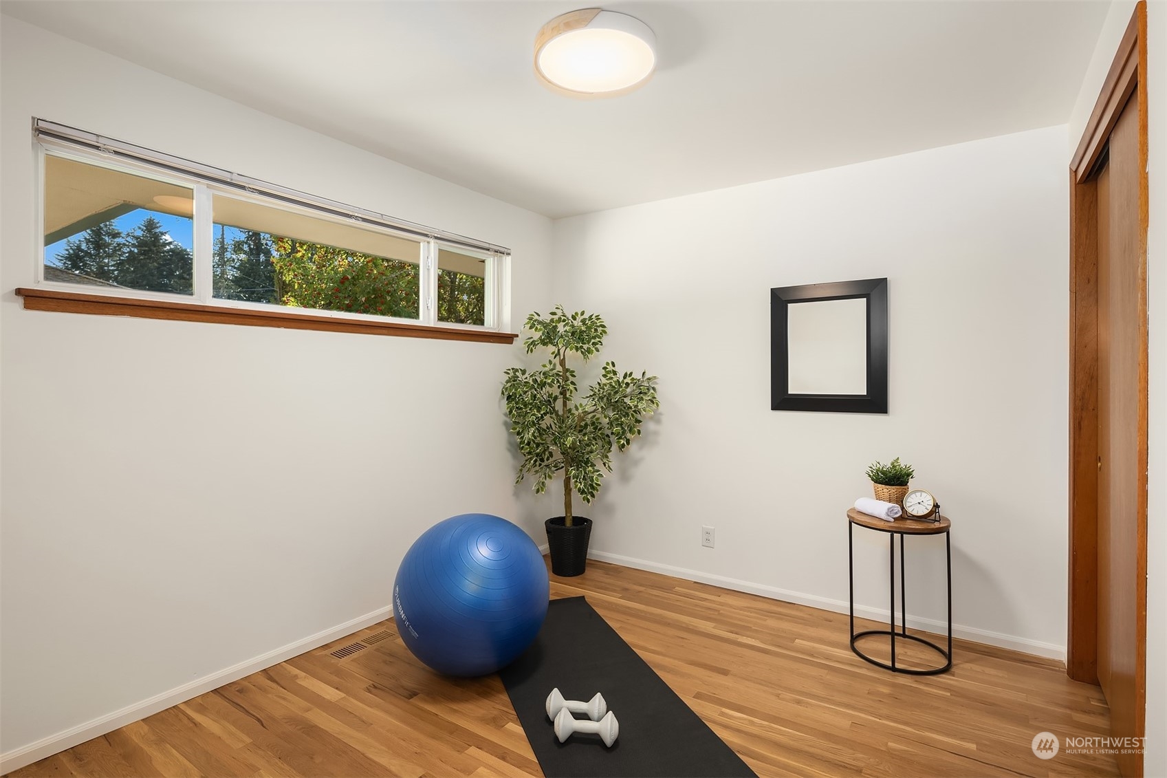 1834 North 183rd Street Shoreline, WA 98133 - Photo 22 of 40 a view of a livingroom with wooden floor and a potted plant
