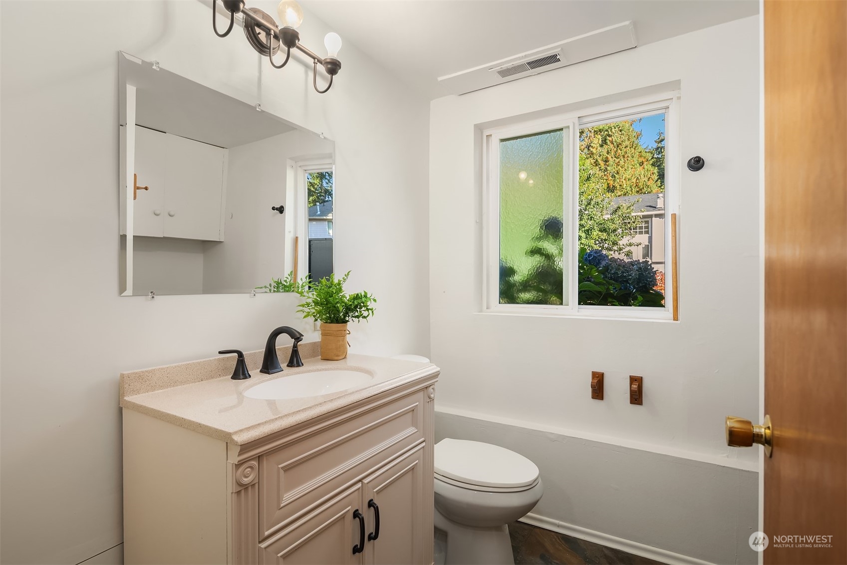 1834 North 183rd Street Shoreline, WA 98133 - Photo 28 of 40 a bathroom with a sink a toilet and a window