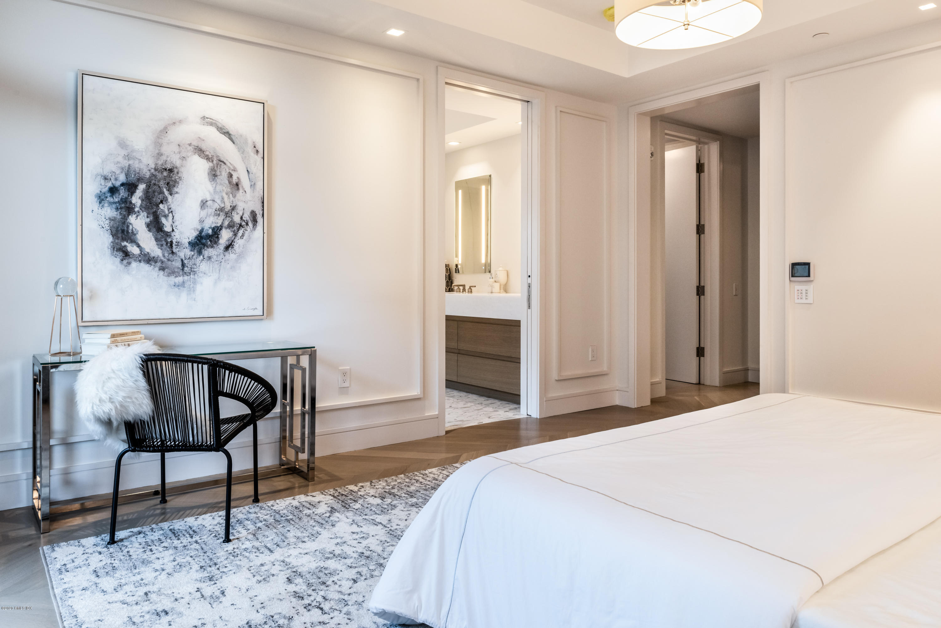 125 Field Point Road, Unit 1A Greenwich, CT 06830 - Photo 11 of 25 a bedroom with a bed and a painting on the wall