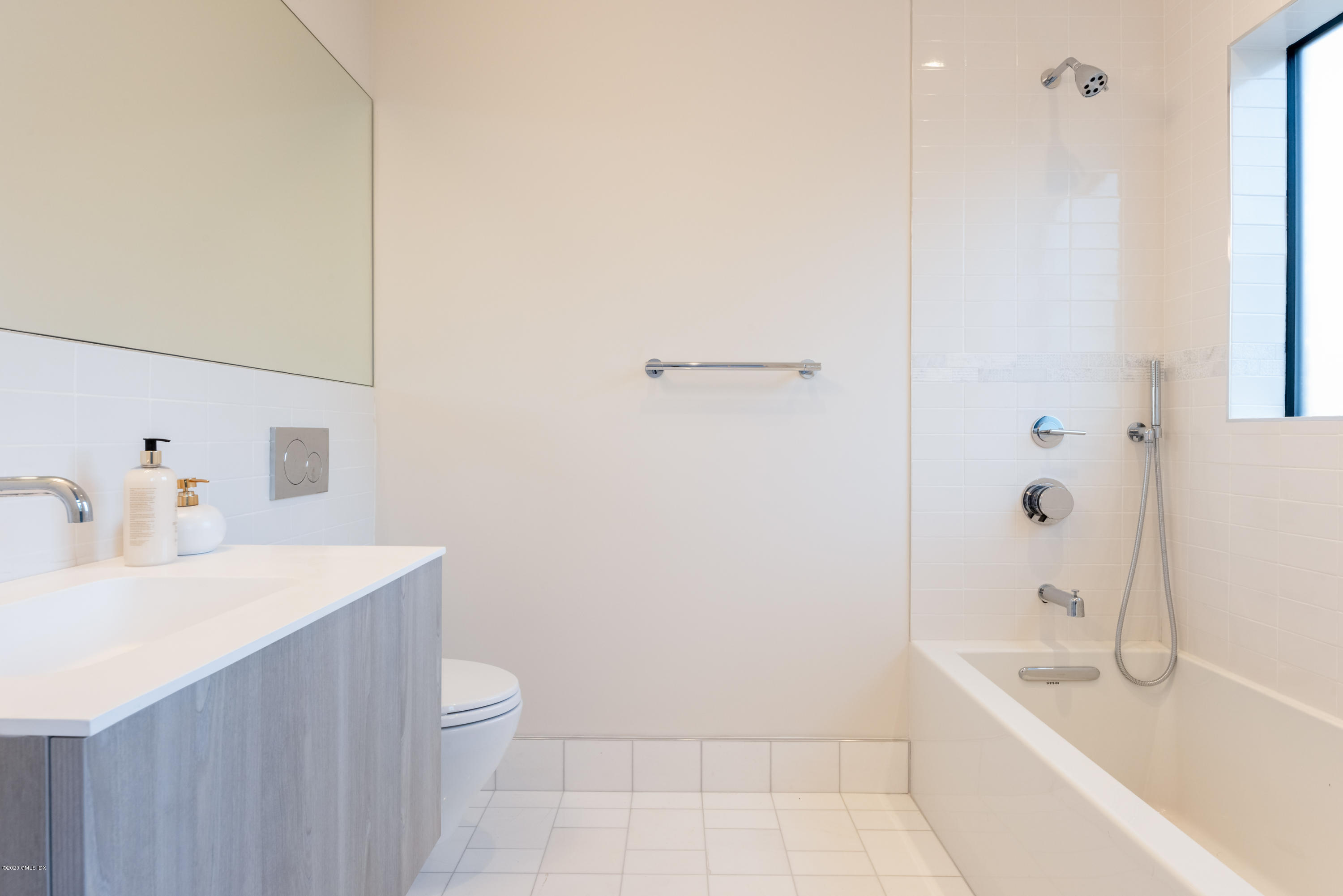 125 Field Point Road, Unit 1A Greenwich, CT 06830 - Photo 16 of 25 a bathroom with a sink a toilet and shower