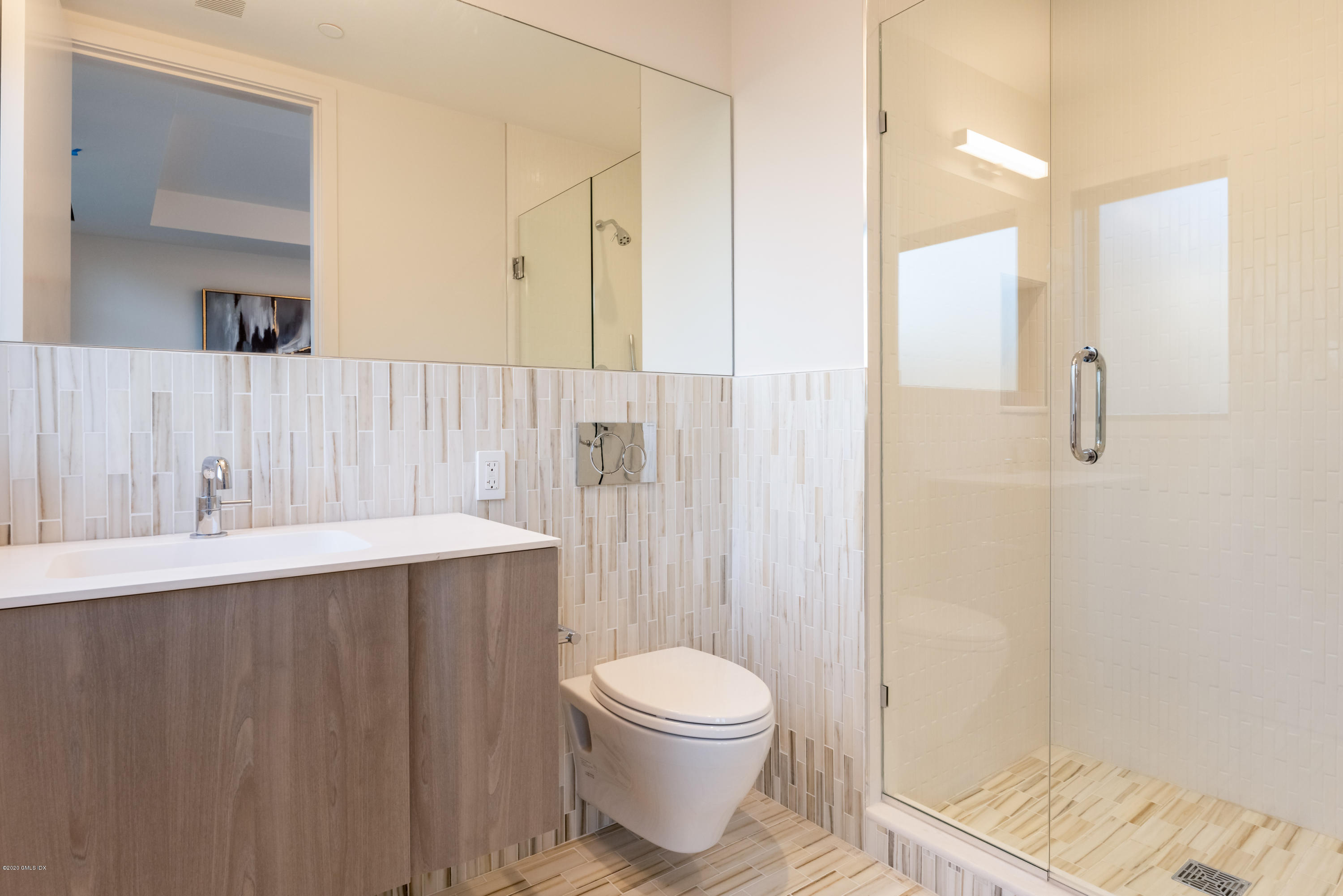125 Field Point Road, Unit 1A Greenwich, CT 06830 - Photo 18 of 25 a bathroom with a sink a toilet and shower