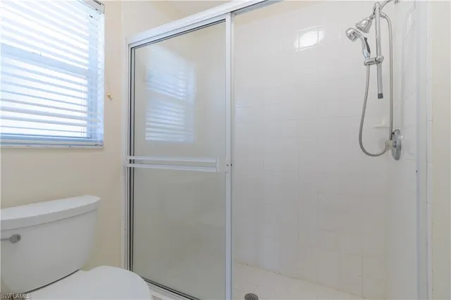 a bathroom with a shower and a toilet