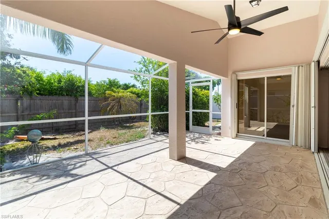 a view of a swimming pool with a lounge chairs in a patio
