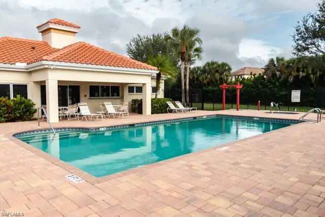 a view of a house with swimming pool and a yard