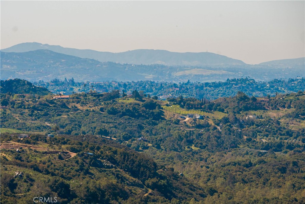 22103 Carancho Road Temecula, CA 92590 - Photo 16 of 27 a view of a lush green hillside and houses