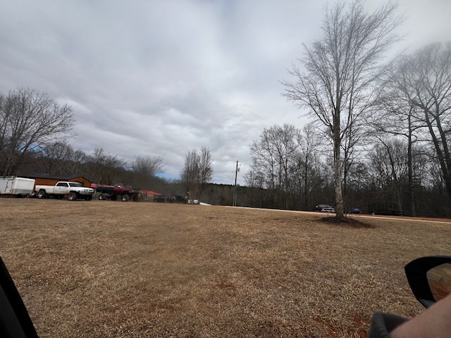 141 Windy Hill Lane Seneca, SC 29678 - Photo 3 of 3 Expansive outdoor space with mature trees and a vast lawn.