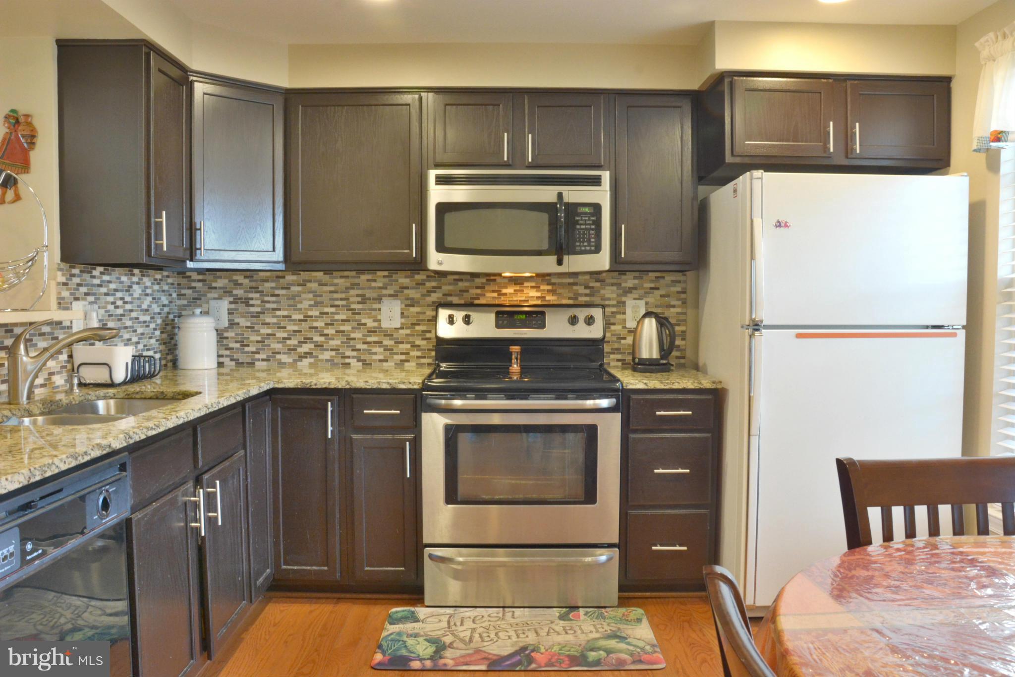 45322 Gable Square Sterling, VA 20164 - Photo 12 of 30 a kitchen with stainless steel appliances a stove a sink and a microwave