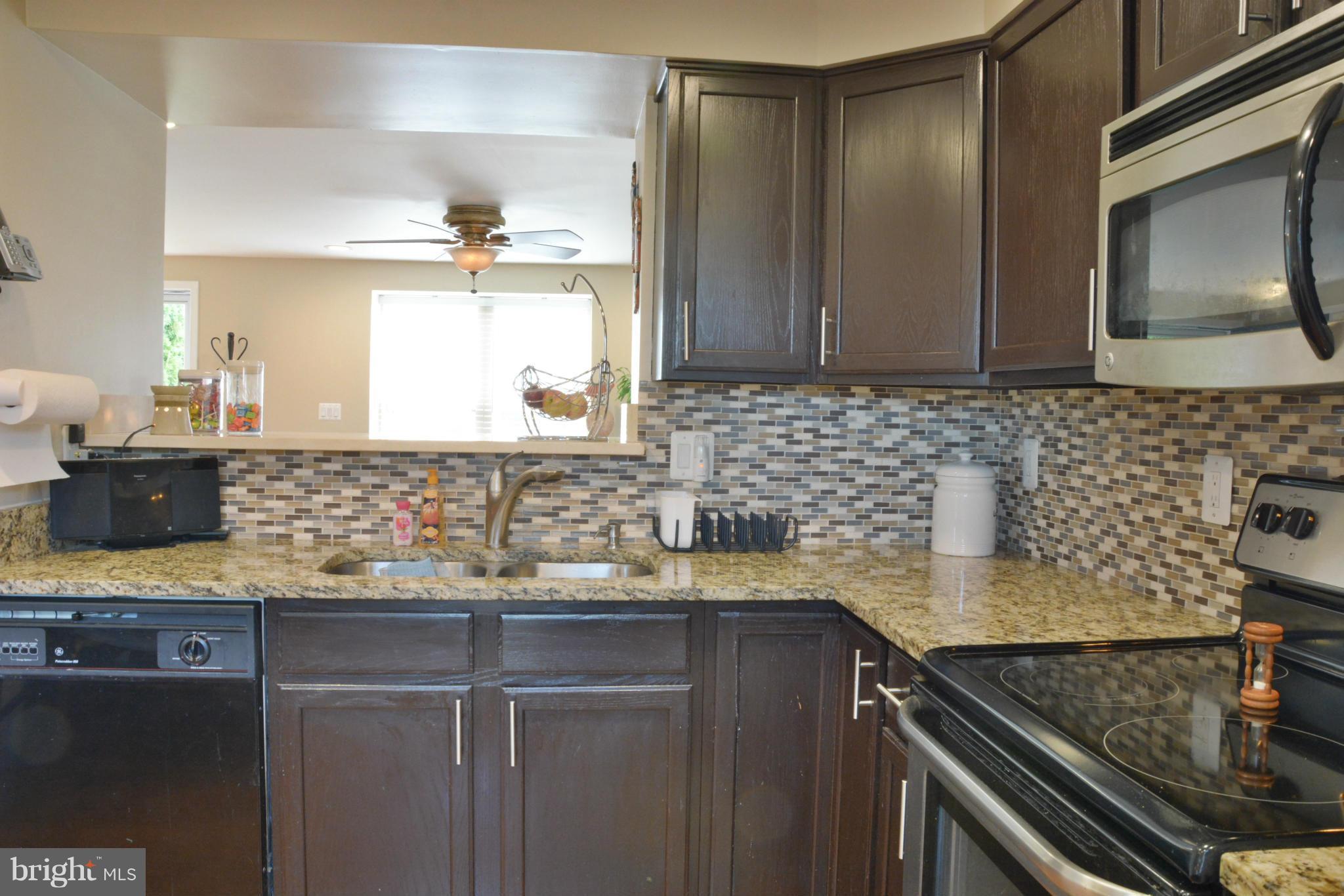 45322 Gable Square Sterling, VA 20164 - Photo 13 of 30 a kitchen with a sink stove and cabinets