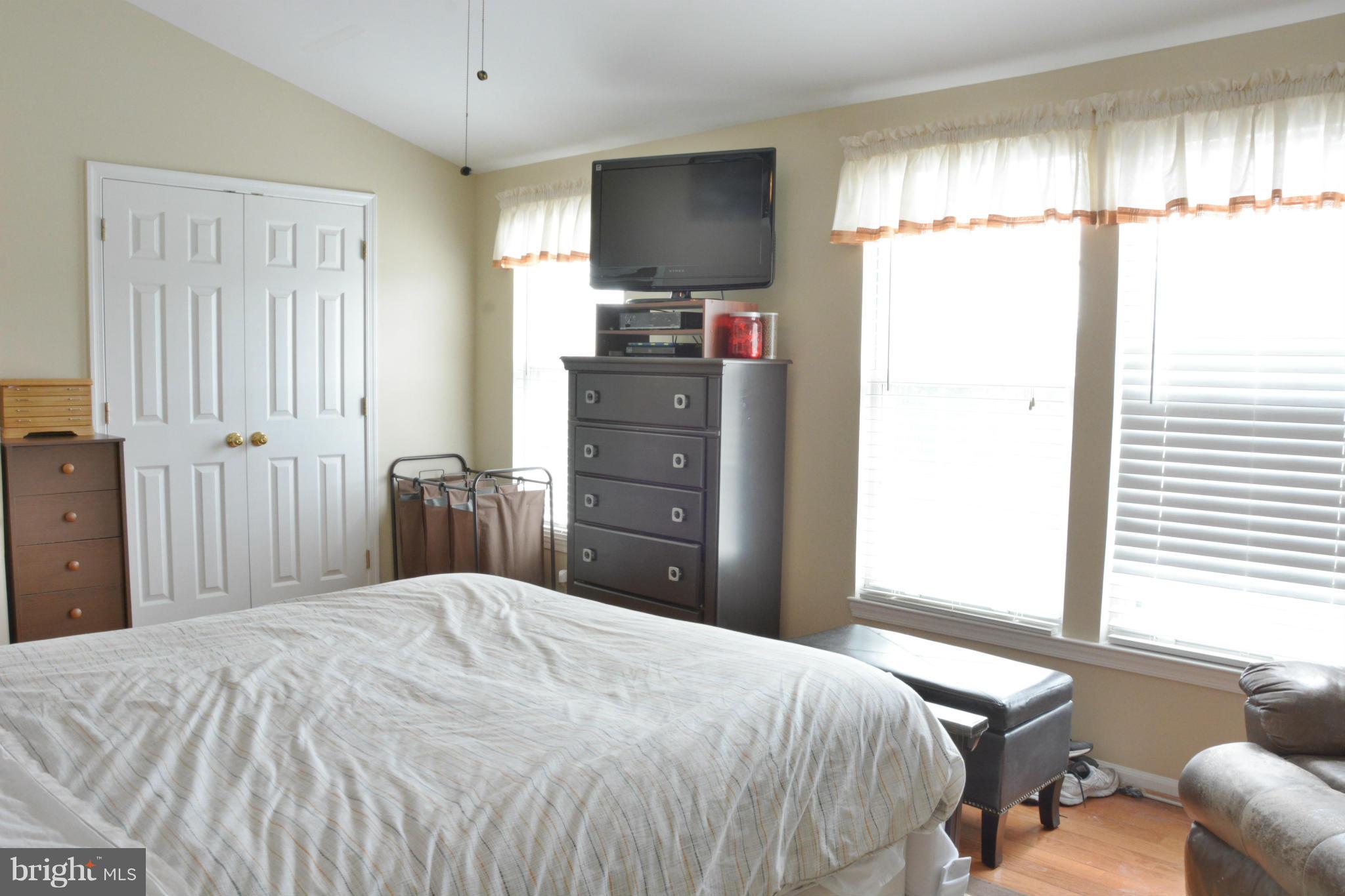 45322 Gable Square Sterling, VA 20164 - Photo 15 of 30 a bedroom with a bed and a flat tv screen