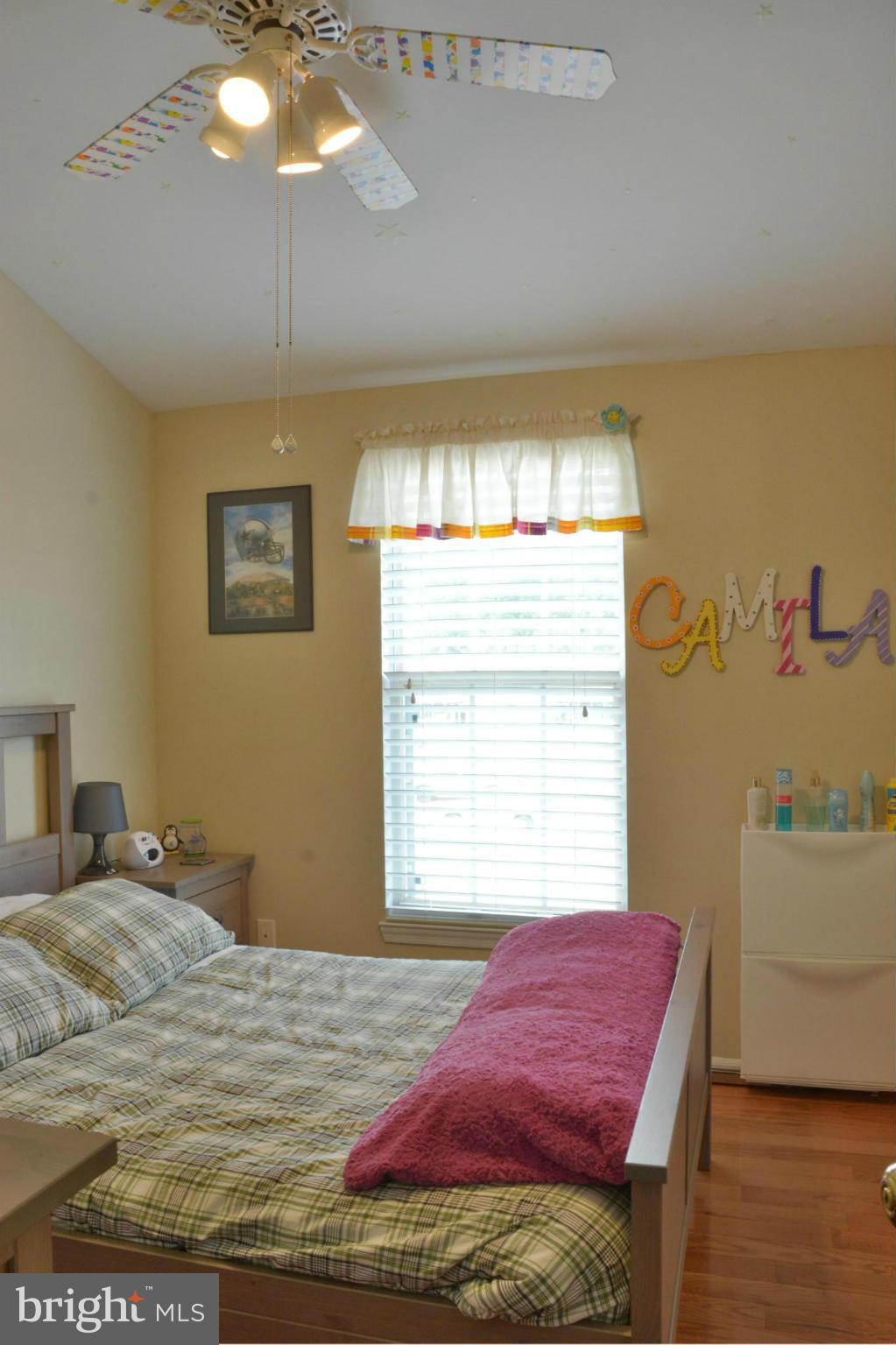 45322 Gable Square Sterling, VA 20164 - Photo 18 of 30 a bedroom with a bed and a chandelier