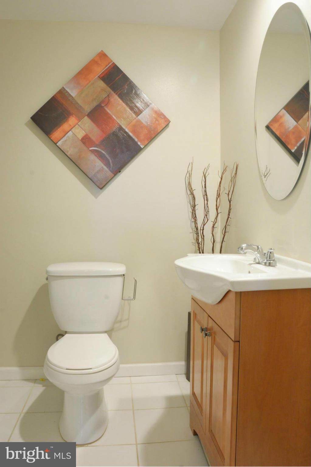 45322 Gable Square Sterling, VA 20164 - Photo 23 of 30 a white toilet sitting next to a bathroom sink