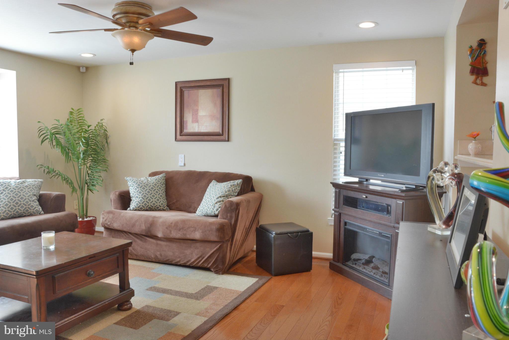 45322 Gable Square Sterling, VA 20164 - Photo 7 of 30 a living room with furniture a flat screen tv and a window