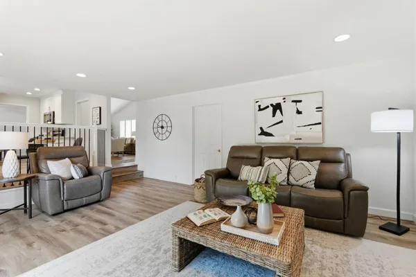 a living room with furniture and wooden floor