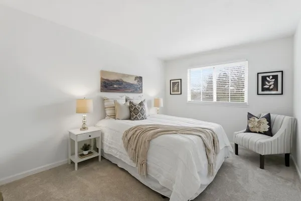 a bedroom with a bed and a couch