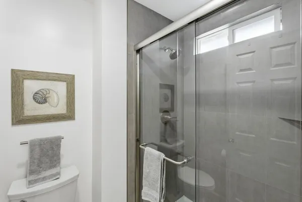 a bathroom with a shower and a mirror