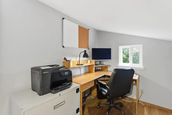 a view of workspace with wooden floor windows