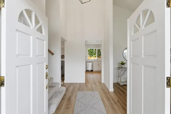 a view of a hallway view with wooden floor and staircase