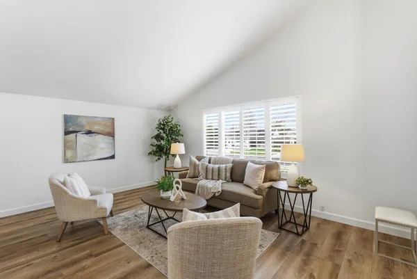 a living room with furniture and a potted plant