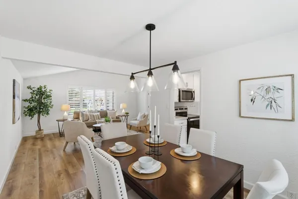 a dining room with furniture and wooden floor