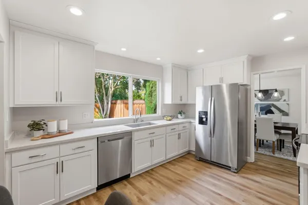 a kitchen with stainless steel appliances granite countertop a refrigerator sink and cabinets