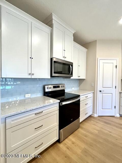 3796 Eagle Rock Road Middleburg, FL 32068 - Photo 4 of 7 a kitchen with granite countertop cabinets stainless steel appliances and a wooden floor