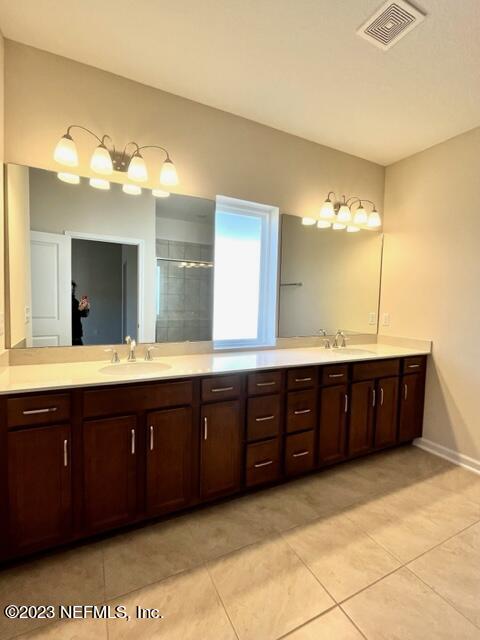 3796 Eagle Rock Road Middleburg, FL 32068 - Photo 6 of 7 a spacious bathroom with a granite countertop double vanity sink a mirror and a bathtub
