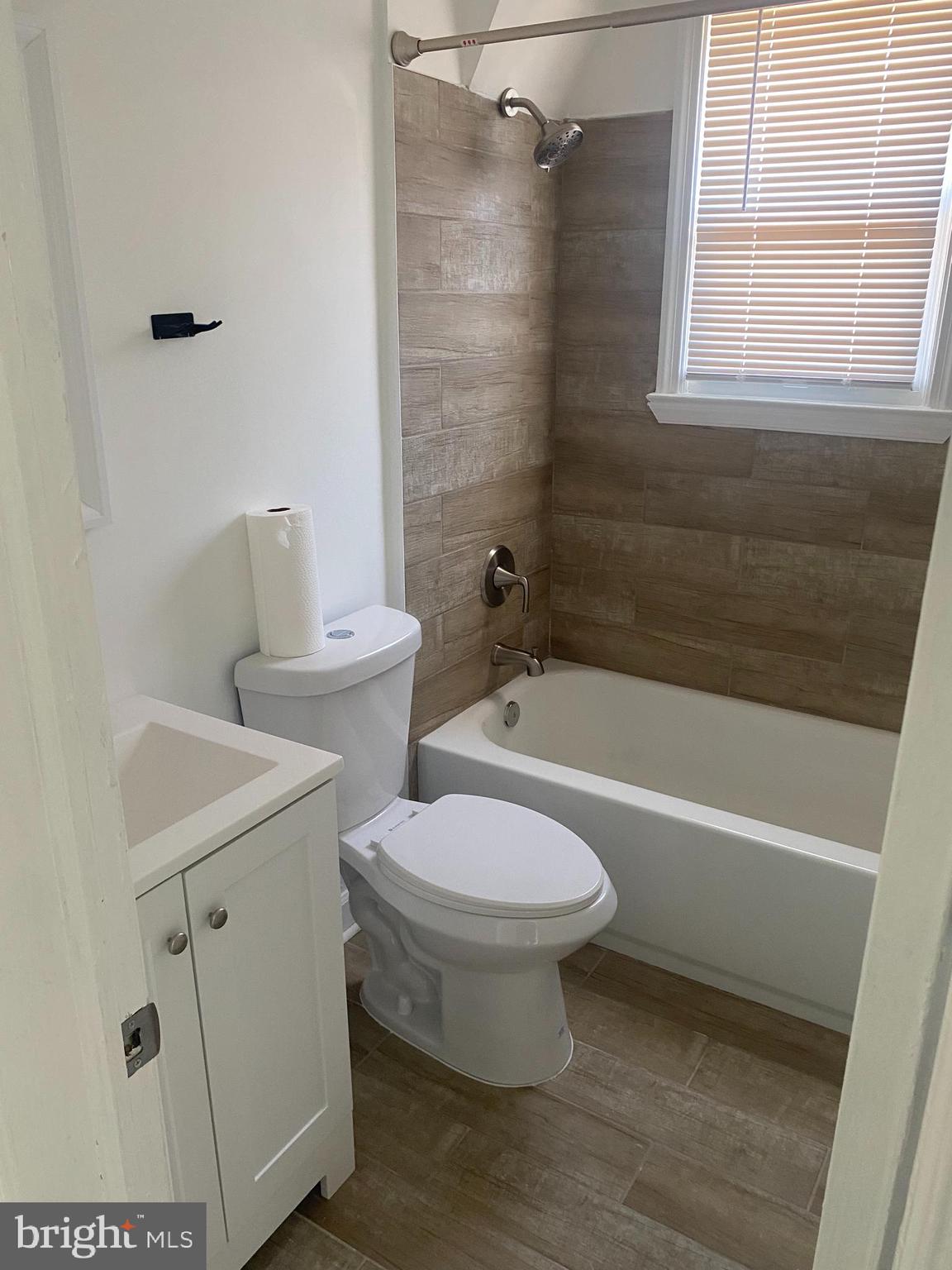3643 Greenvale Road Baltimore, MD 21229 - Photo 16 of 23 a bathroom with a sink a toilet and a bathtub