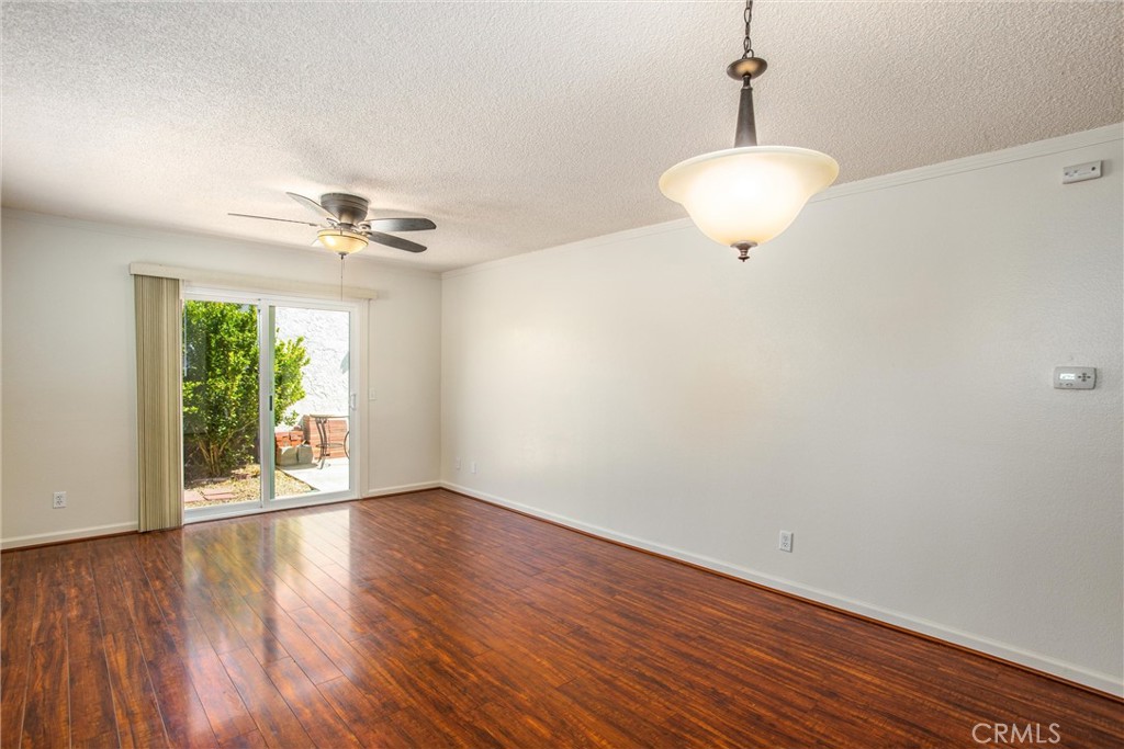 29252 Murrieta Road Menifee, CA 92586 - Photo 11 of 28 a view of an empty room with a window and wooden floor