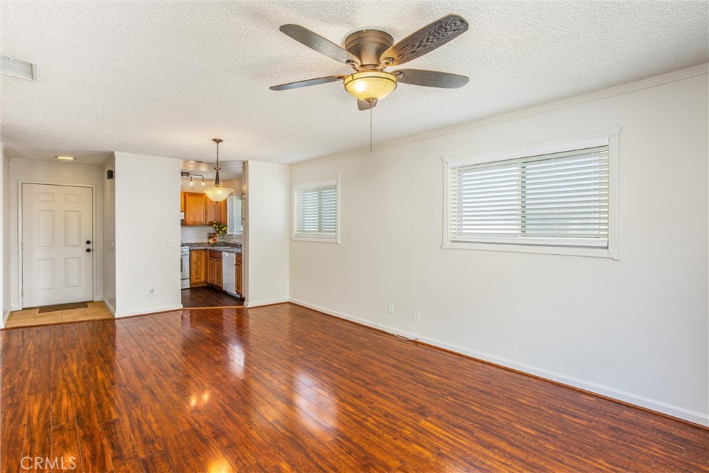 29252 Murrieta Road Menifee, CA 92586 - Photo 13 of 28 a view of an empty room with a window and wooden floor