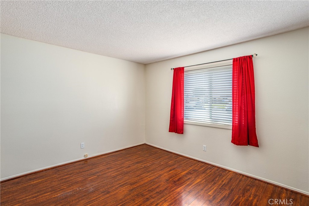 29252 Murrieta Road Menifee, CA 92586 - Photo 16 of 28 a view of a room with wooden floor and a window