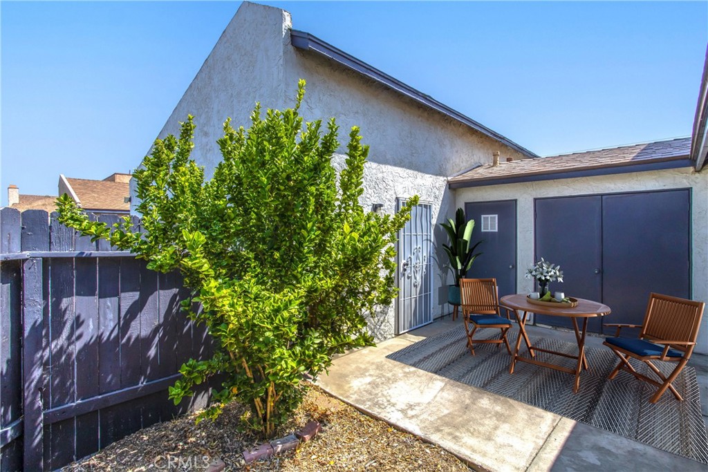 29252 Murrieta Road Menifee, CA 92586 - Photo 18 of 28 a view of a backyard with chairs potted plants and wooden fence