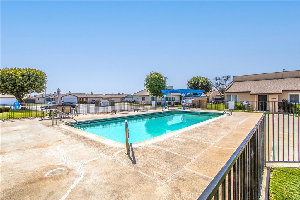 29252 Murrieta Road Menifee, CA 92586 - Photo 24 of 28 a view of a swimming pool with an outdoor seating and a yard