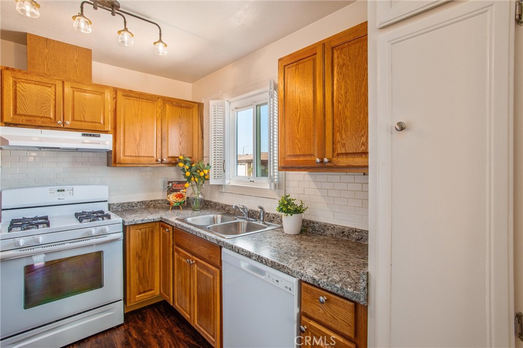 29252 Murrieta Road Menifee, CA 92586 - Photo 3 of 28 a kitchen with stainless steel appliances granite countertop a sink stove and cabinets