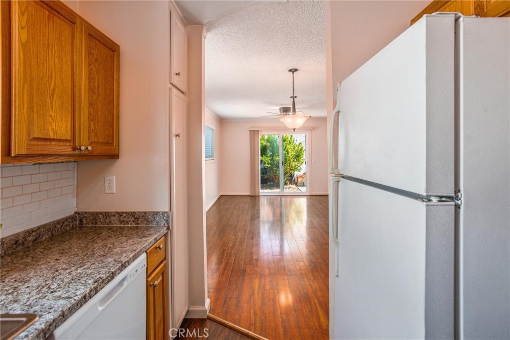 29252 Murrieta Road Menifee, CA 92586 - Photo 6 of 28 a kitchen with a refrigerator a sink and a stove