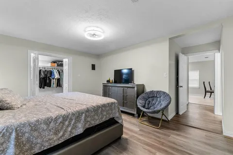 a bedroom with a bed and a chair with the outer view