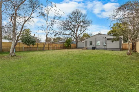 a view of house with a yard