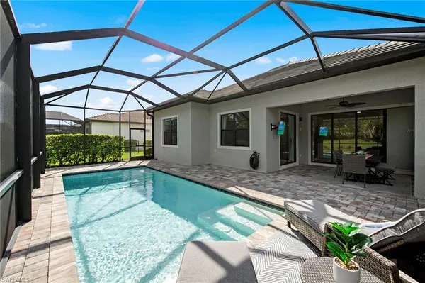 a swimming pool with yard outdoor seating and outdoor seating