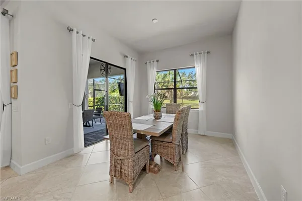 a view of a dining room with furniture a rug and wooden floor