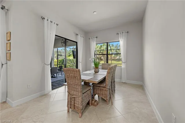 a view of a dining room with furniture a rug and wooden floor