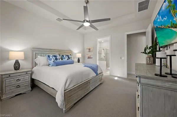 a bedroom with a bed and a mirror on the dresser