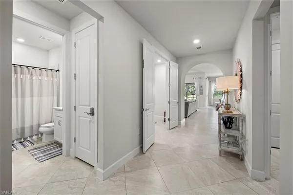 a view of a hallway with bathroom and bathroom